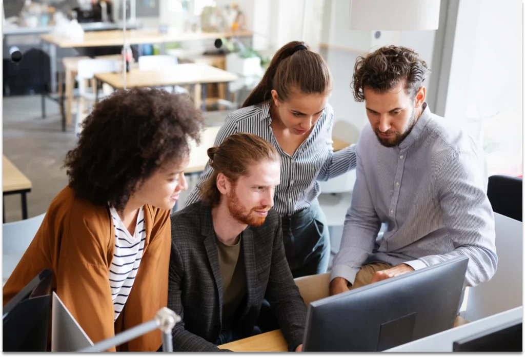 Photo: cheerful coworkers in office meeting.
